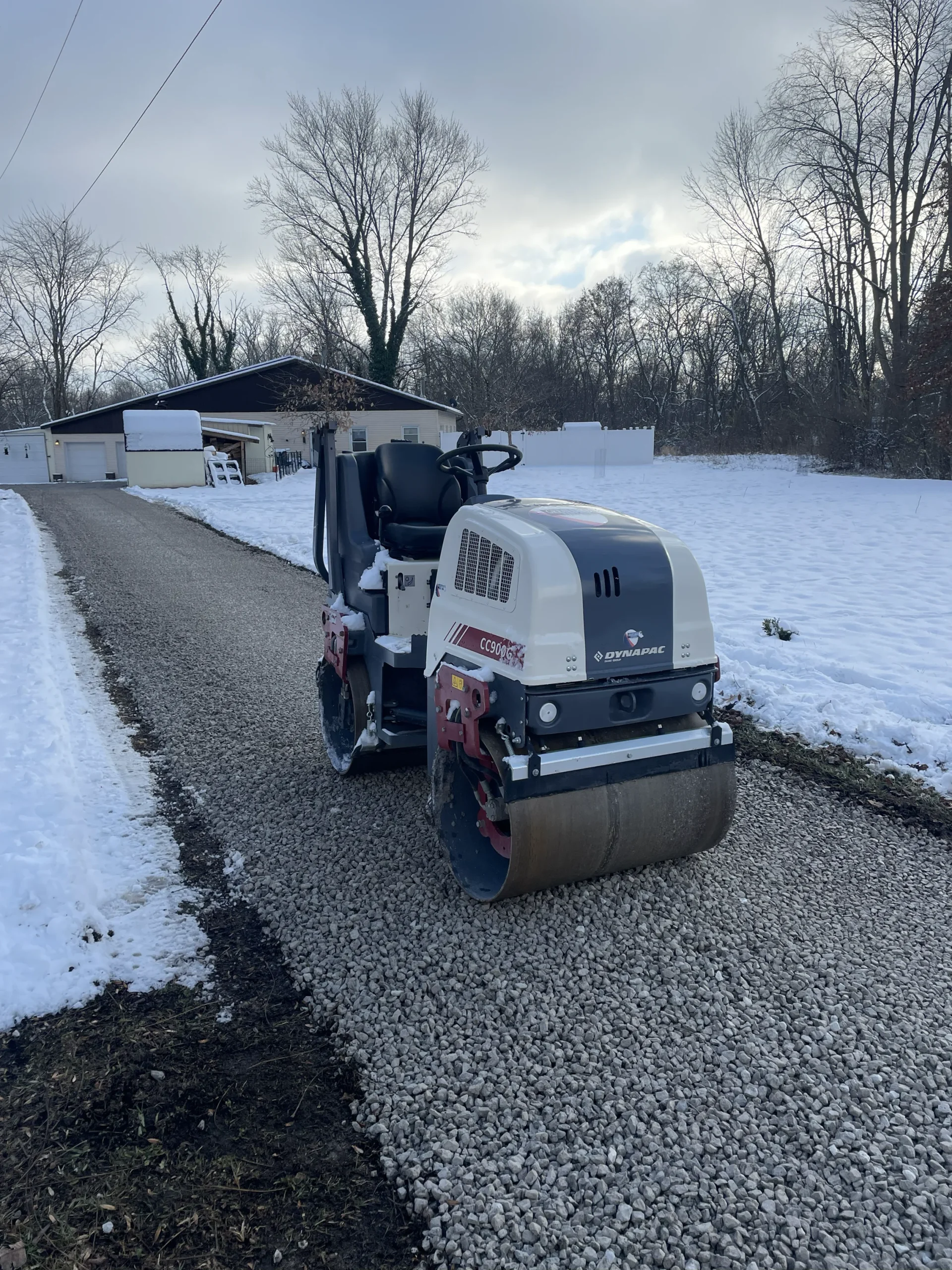 Better Way Land Management LLC Dynapac CC900 roller compacting gravel stone driveway base residential property winter OH