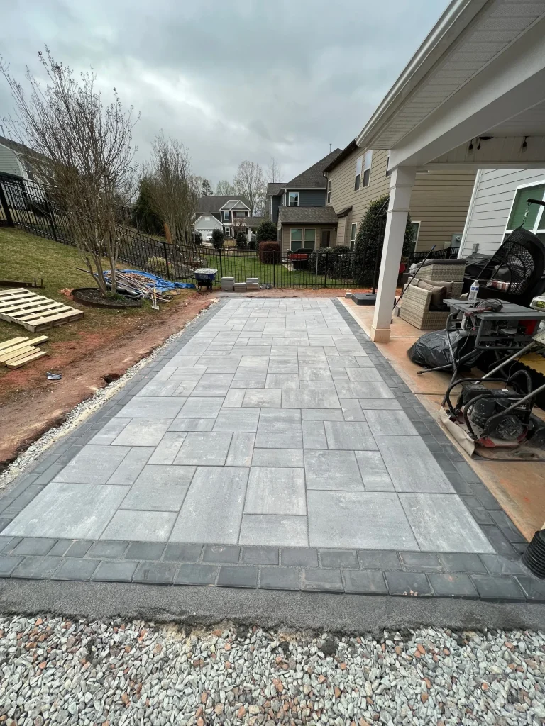 Better Way Land Management LLC completed paver patio from landscaping services in Toledo with dark border edging