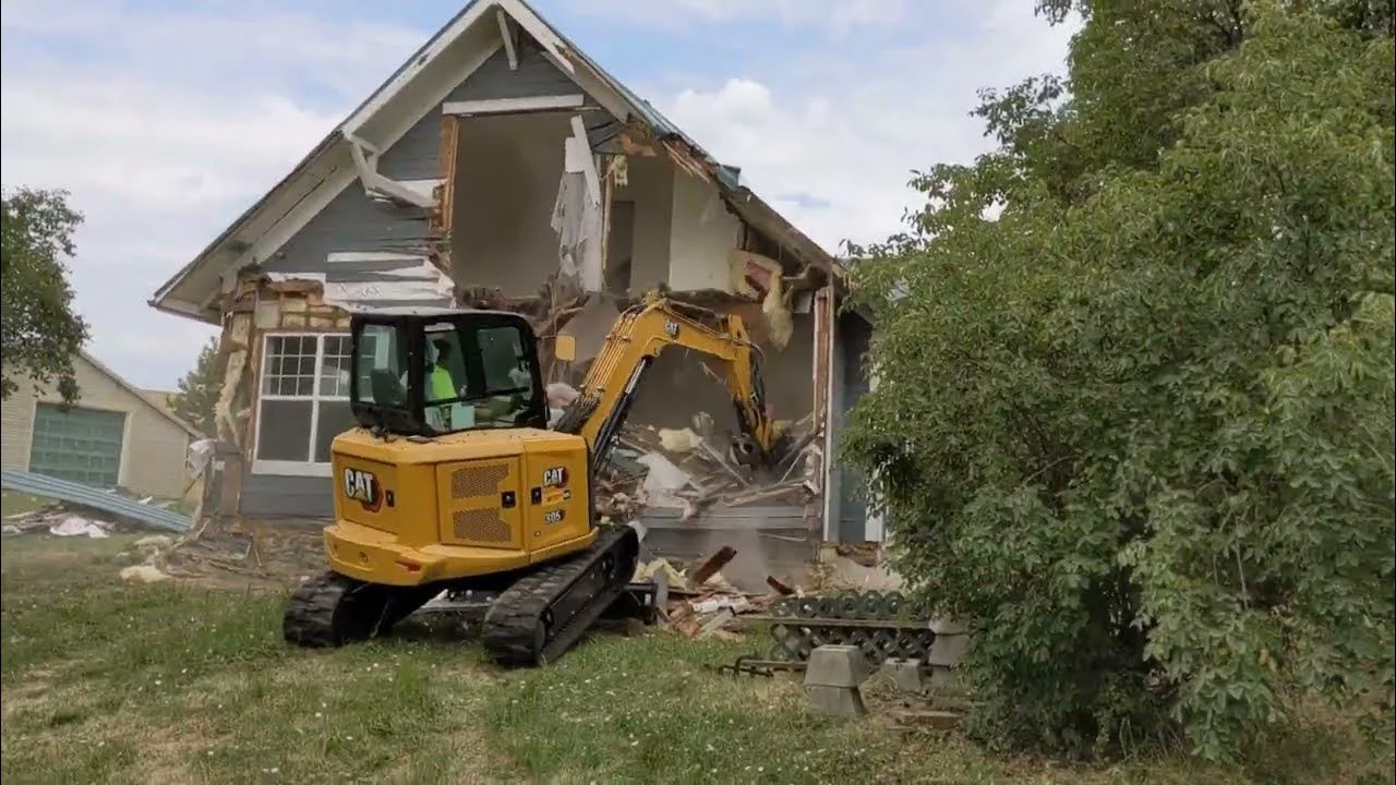 Better Way Land Management LLC operator using CAT mini excavator to demolish residential house structure in Ohio
