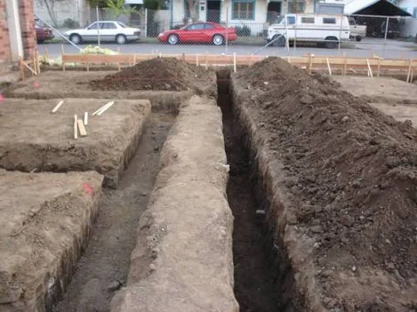 Better Way Land Management LLC foundation trenches excavated for residential construction with wooden form stakes in Ohio